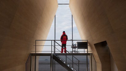 Person standing between two design structures