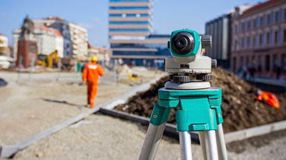 Building site with measuring instrument as main focus
