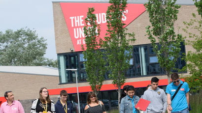 People walking past The Students' Union at UWE building on Frenchay Campus.