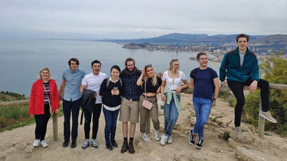 Group of students gathered on a coastal field trip 