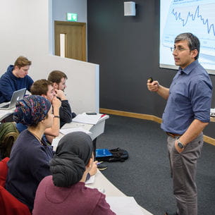 A lecturer teaching a group of students