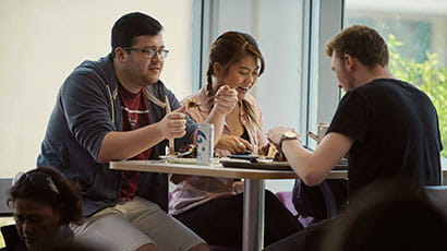 Students eating at a table in their accommodation