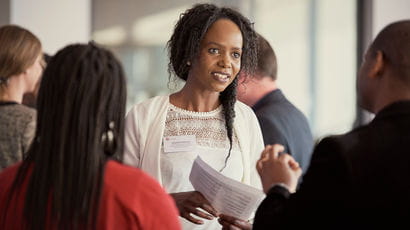 A women in discussion with a couple of people.