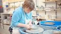 A lady making pottery