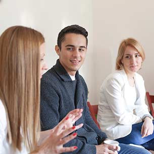 Three students in a group discussion