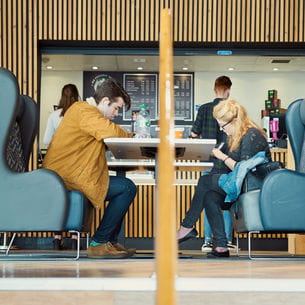 Students sitting in The Students' Union at UWE cafe on Frenchay Campus.