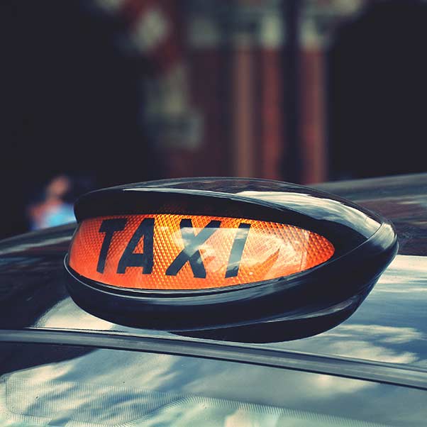 A close up of an illuminated taxi sign