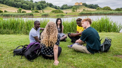 Group of students sitting together and chatting in Stoke Park Estate.