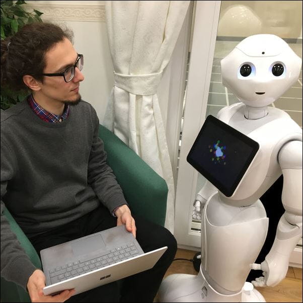 Robotics student working with robot