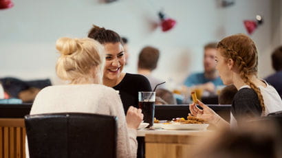 Students chatting over food in the Students' Union bar