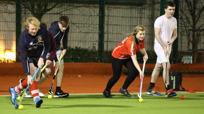 Students playing hockey.