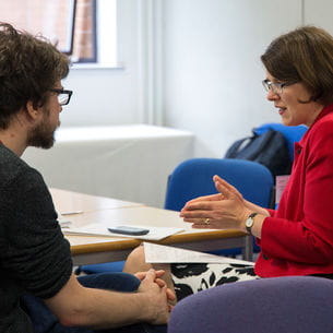 A lecturer talking to a student