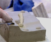 Malcolm Challinor preparing the mould of a figurine's arm