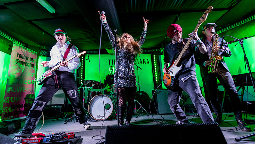 4 members of a band on stage