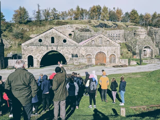 Historic ironworks, Blaenavon, Wales – Students observe and record information about the historic ironworks site as a part of their day's fieldwork exploring deindustrialisation in small towns and communities in the South Wales valleys.
