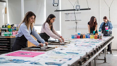 Students and staff working in a design studio
