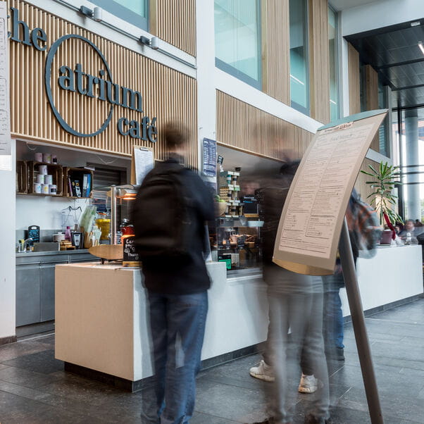 A member of staff ordering food at the Atrium cafe on Frenchay campus.