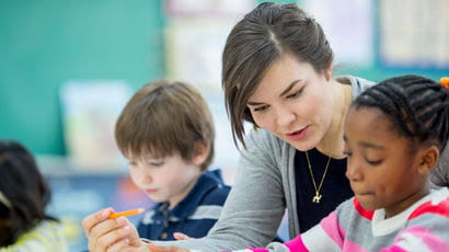 Teaching student with two children in a school.