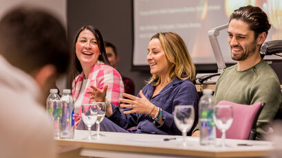 A gathering at an event with people discussing ideas.
