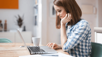 A student on a laptop reading.