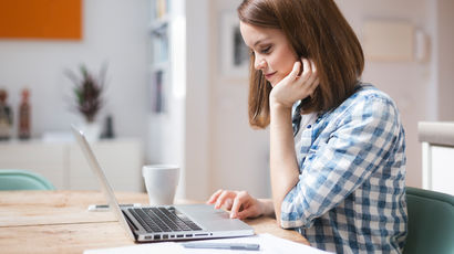 A student on a laptop reading.