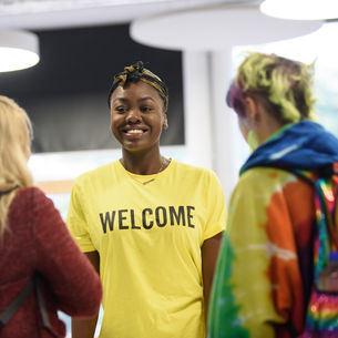Students welcoming prospective students at an Open Day.