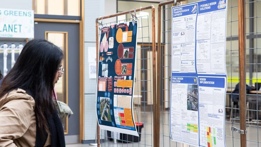 Students gathered around displays during the Engineering Project Week event.