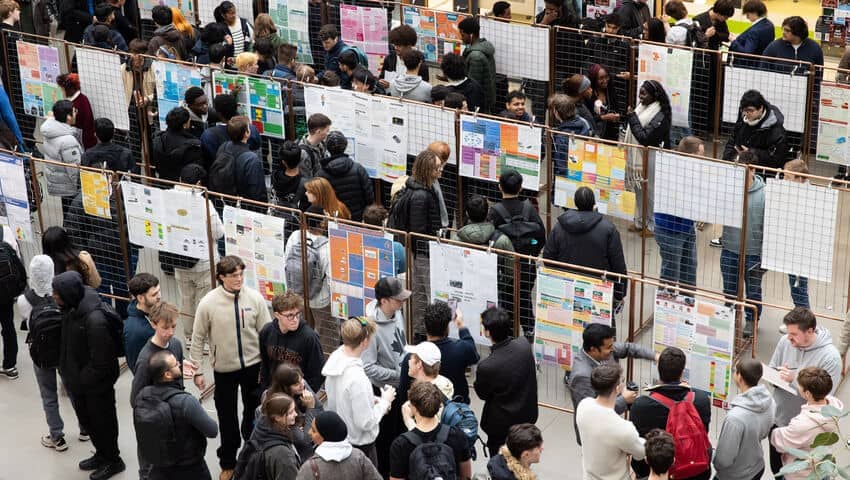 Students gathered around displays during the Engineering Project Week event.