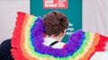 Closeup of someone wearing rainbow wings at Bristol Pride.