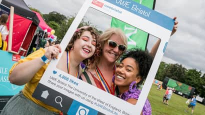 UWE Bristol staff members posing with a photoframe at Bristol Pride.