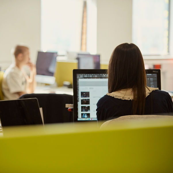 Students using computers in a study room.