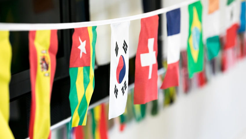 Country flags lined up at an international scholarship event.