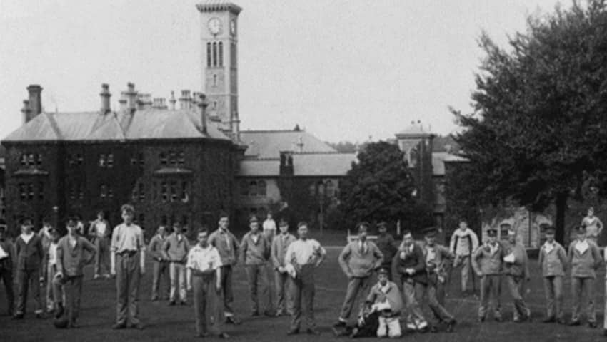 Injured soldiers, now patients, stand in front of Glenside clock tower circa 1919.