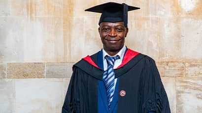 John Adesoye in graduation robes