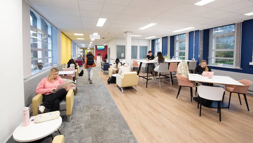 Present day library, with sofas and spaces to work on laptops.