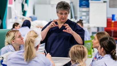 Lecturer addressing a group of nursing students.