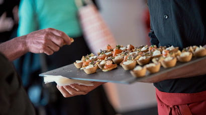 Catering team serving canapes to guests at an event