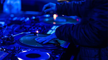 DJ mixing music at a mixing desk