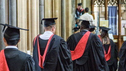 Students at graduation walking into the venue.