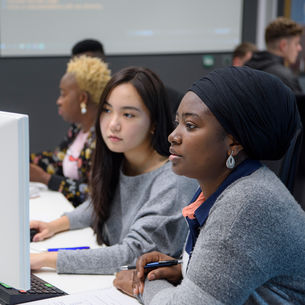 Students working on computers in a study space.