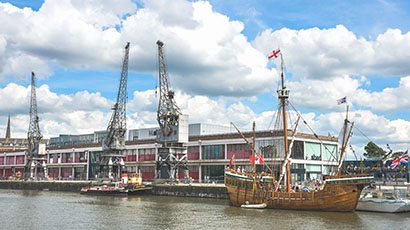 M Shed external view with cranes and The Matthew boat outside.