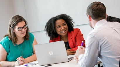 Staff members meeting in an office.