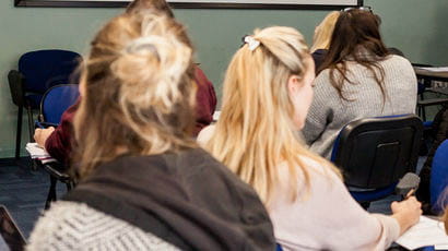 Group of students in a lecture room.