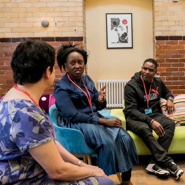 Health and social care students working with patients in a therapy room.