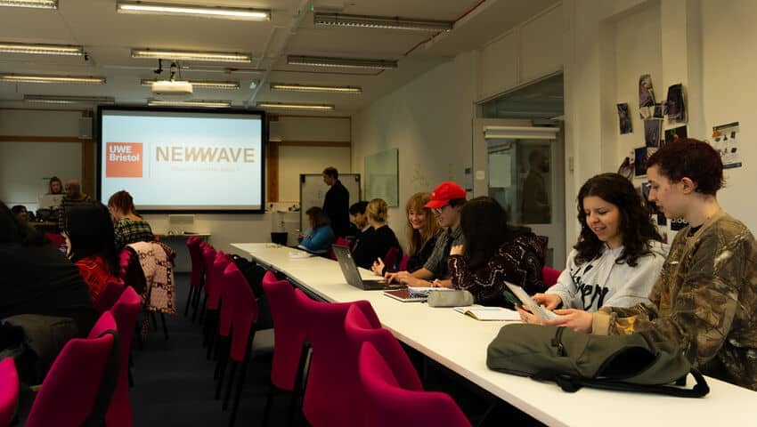 Group of arts students attending a talk from New Wave as part of Professional Project Week.