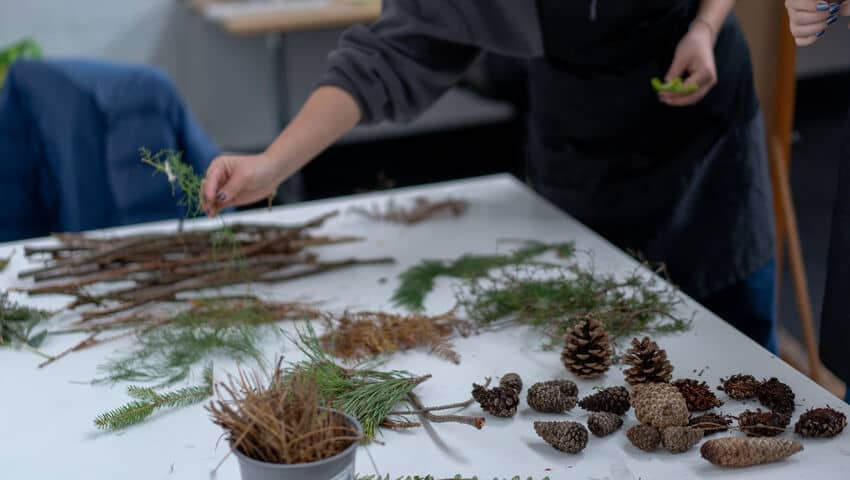 Students selecting natural tools to paint with as part of Drawing Week event