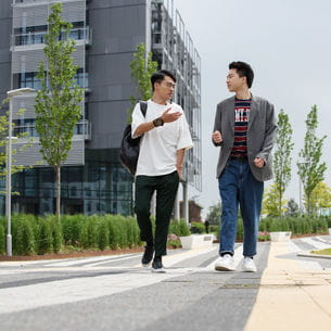 Two people walking and talking together.