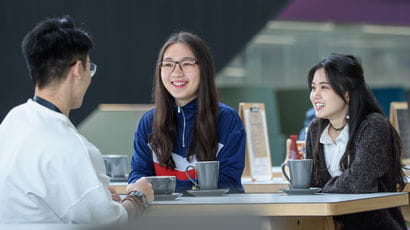 International students talking in a cafe space