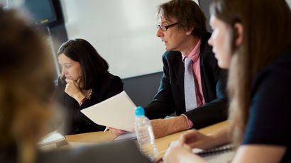 Close up of people at a meeting