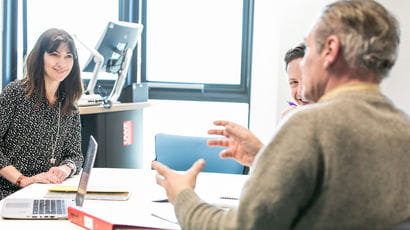 A couple of people in a meeting.